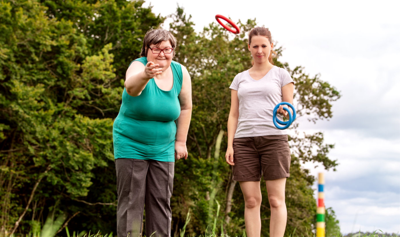 senior woman and caregiver playing