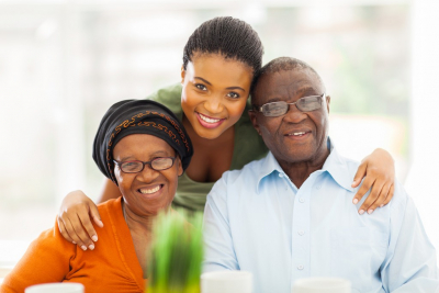 senior couple and caregiver are smiling