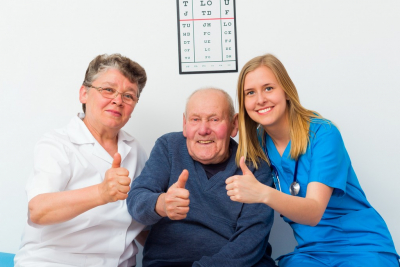 senior couple and nurse doing a thumbs up