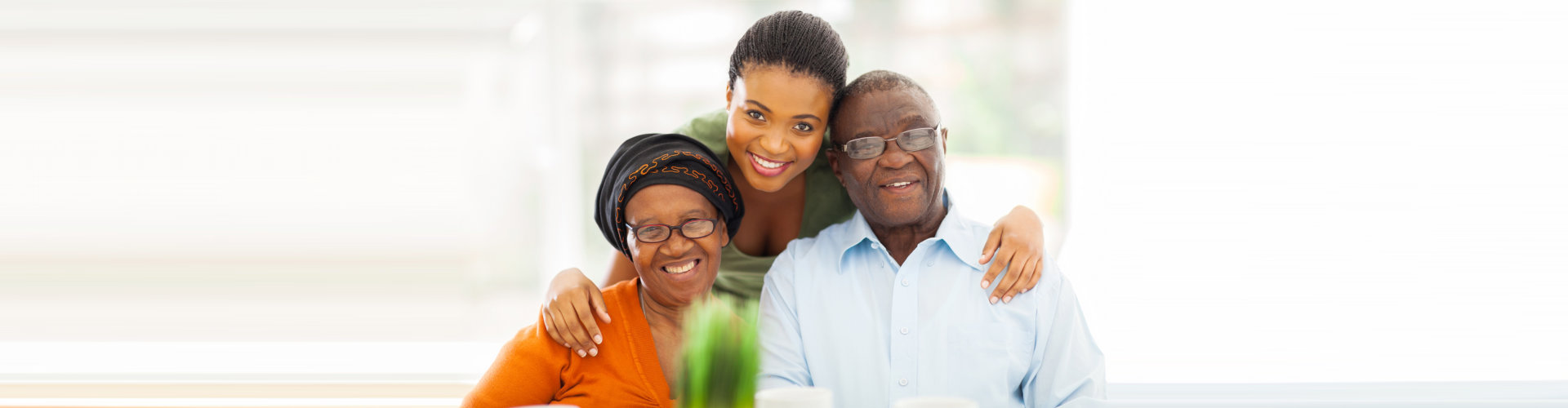 senior couple and caregiver are smiling