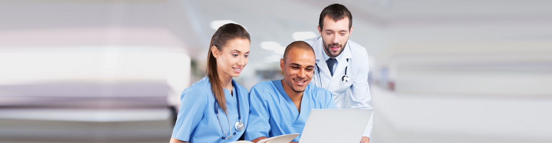 nurses and doctor looking at laptop